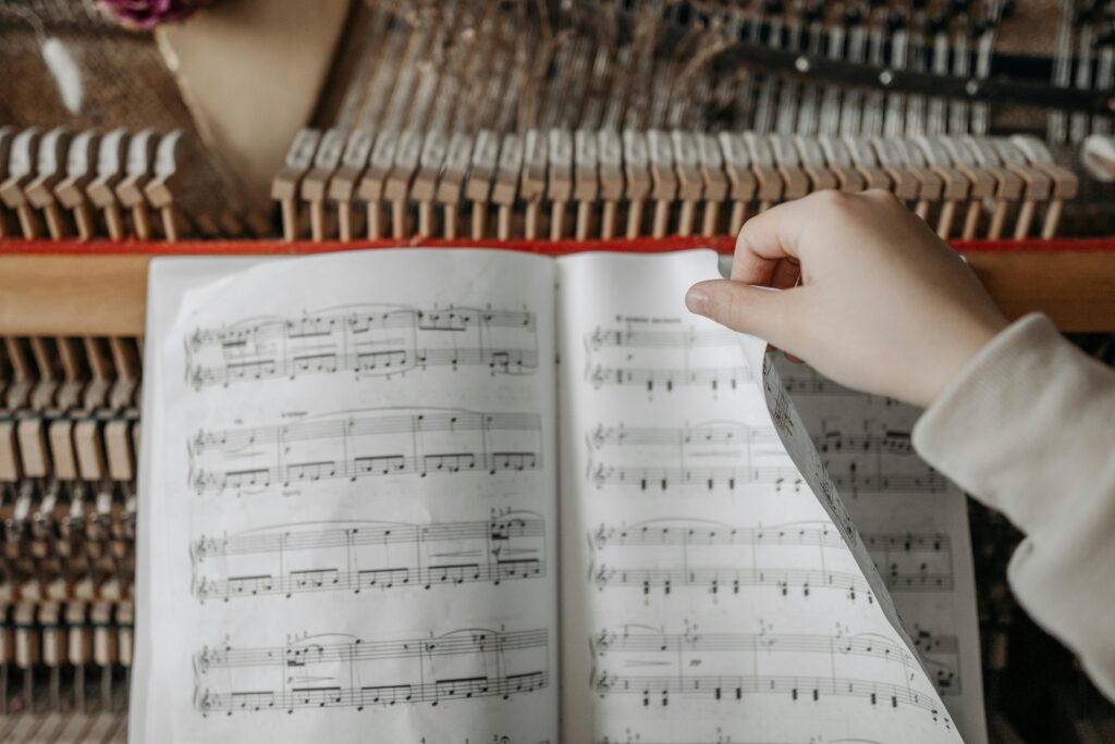 A close-up of a music sheet with notes and chords, representing the creative process in music production for beginners